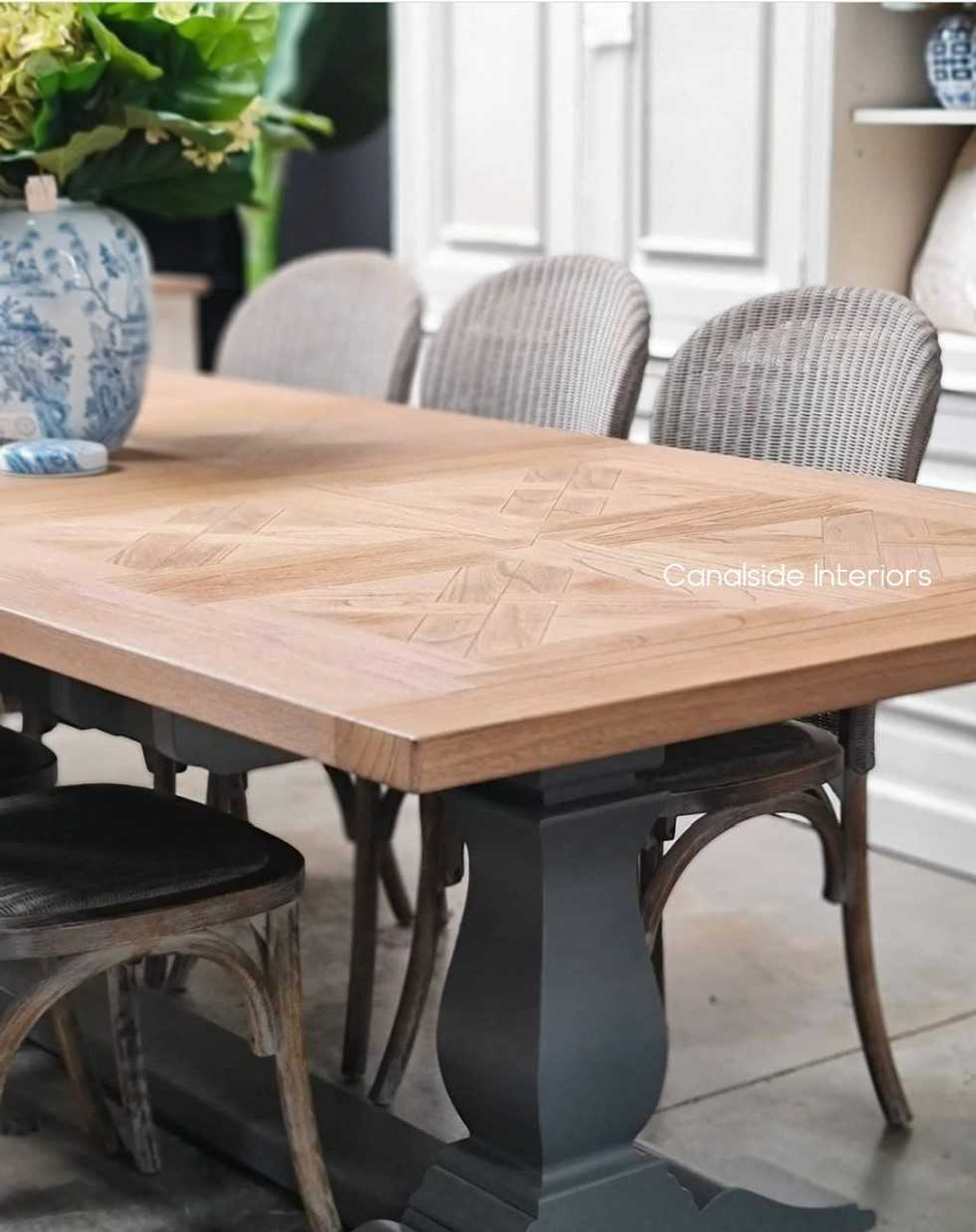 Balmoral Table adorned with decor, demonstrating how its surface can serve both dining and display purposes in a coastal-themed room