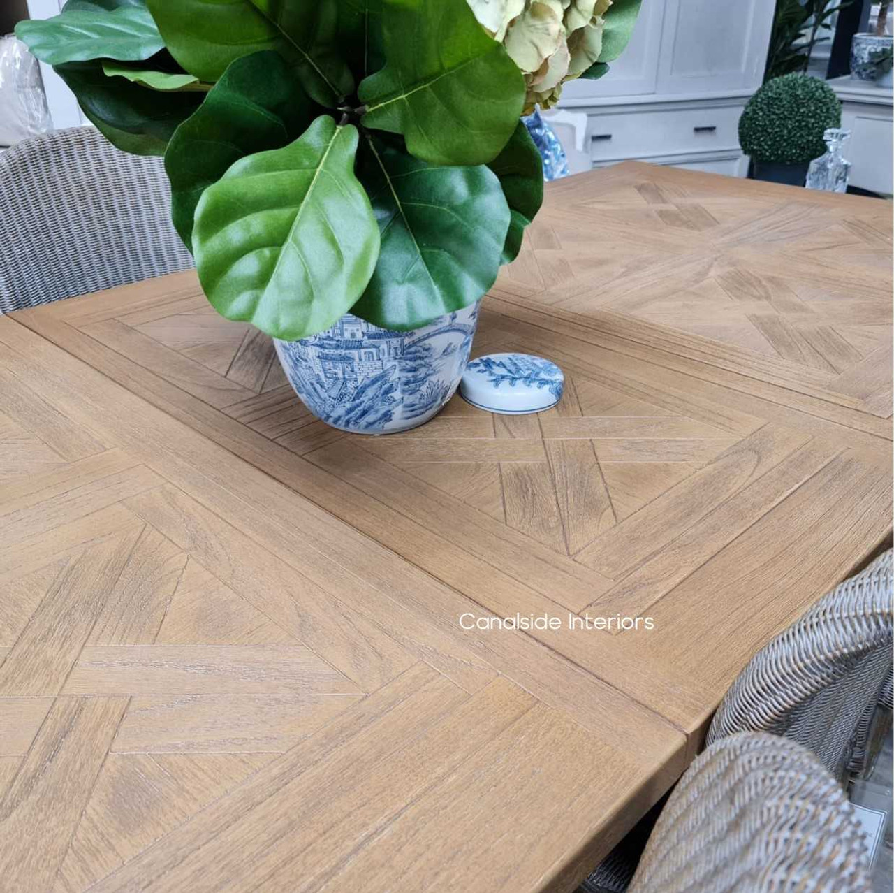 The Balmoral Table's sturdy white cedar construction, shown from the side, with chairs tucked in for a clean, coastal look