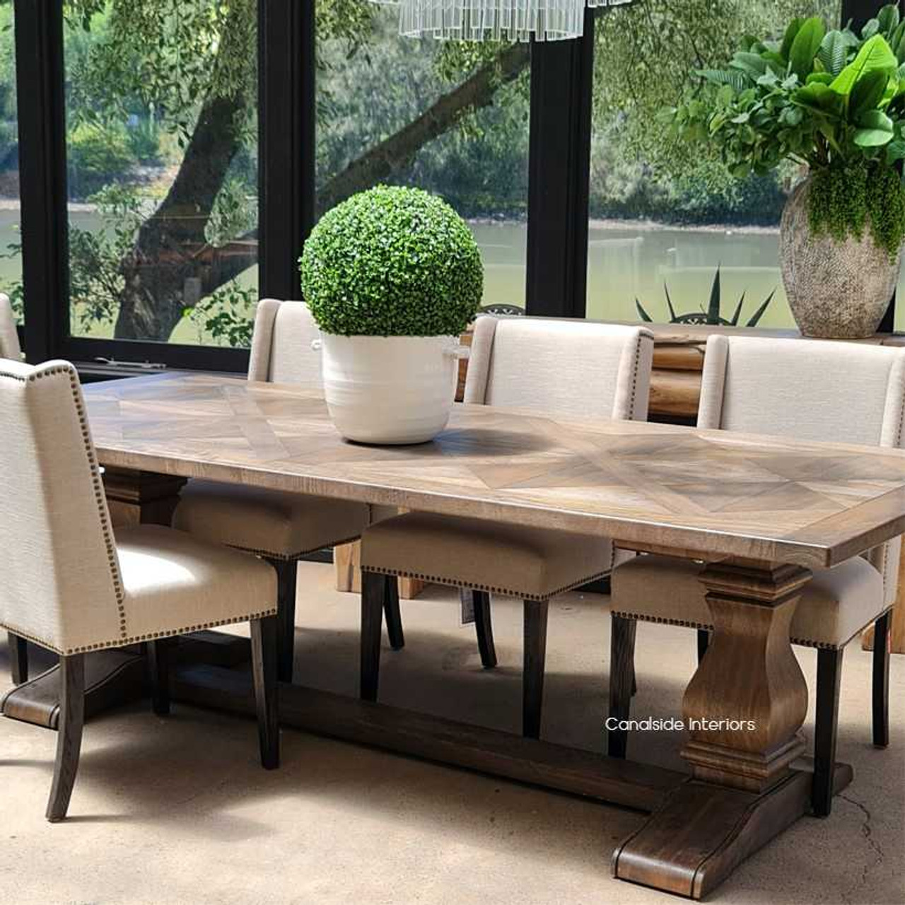 The table set within a minimalist contemporary setting, emphasizing its ability to stand out as a statement piece with its unique design and traditional charm.