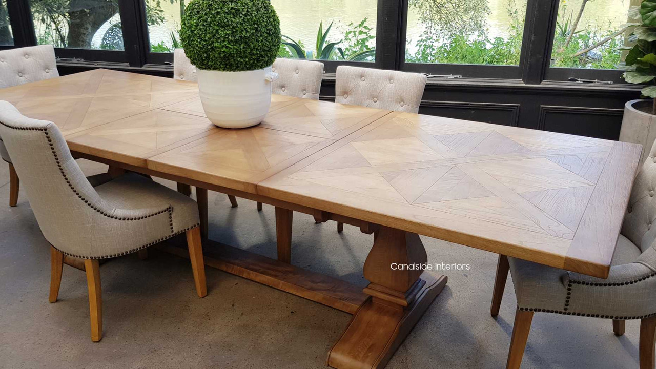 The dining table paired with a mix of chair styles, showing its flexibility in complementing both traditional and contemporary seating.