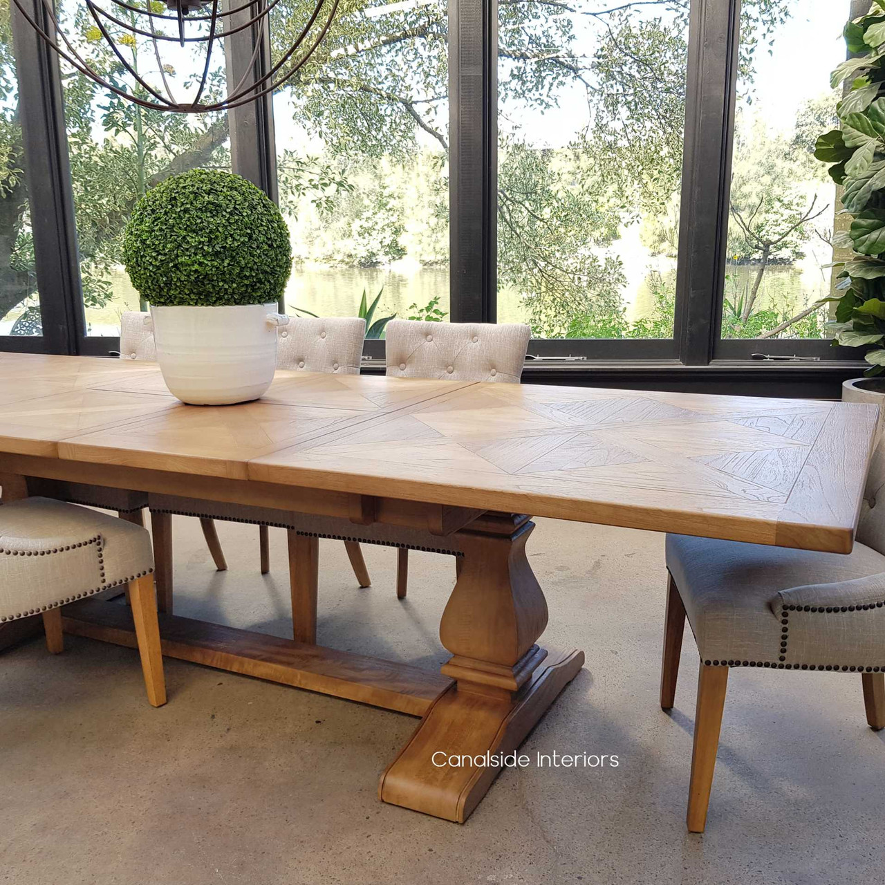 The Hampton Bay Dining Table in a beach house setting, blending seamlessly with coastal decor for a relaxed yet sophisticated dining area.