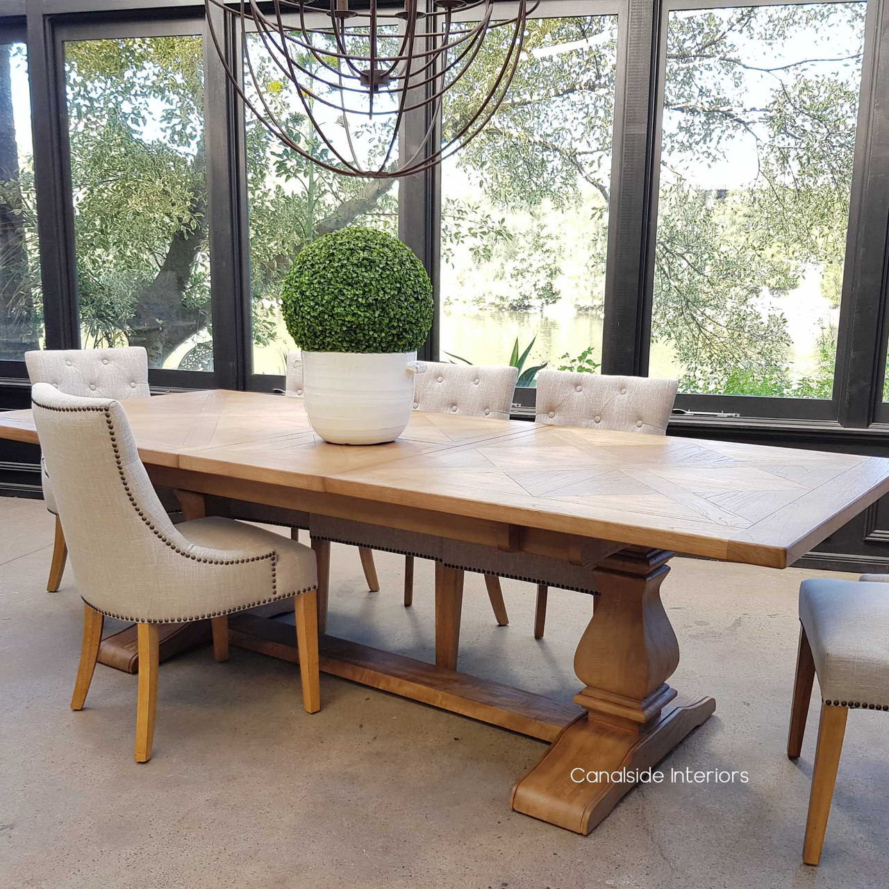 A close view of the pedestal base, emphasizing its intricate design and the solid support it provides to the extendable top.