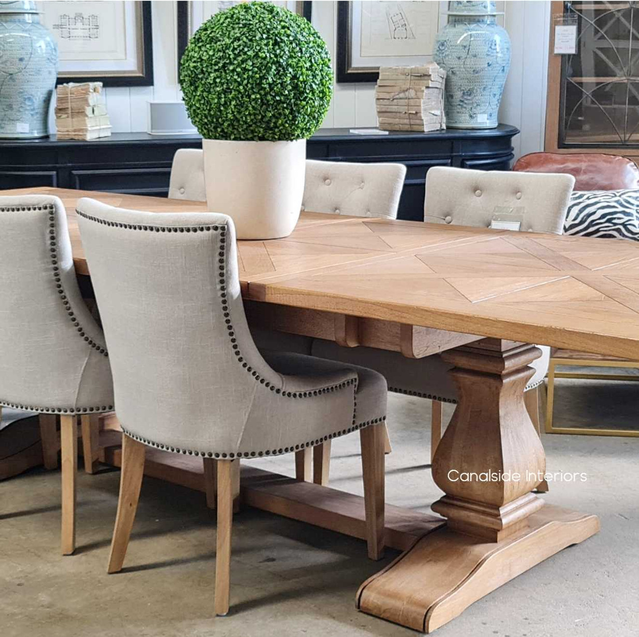 Table partially extended, illustrating the innovative butterfly fold mechanism that allows for smooth and effortless transitioning between sizes.