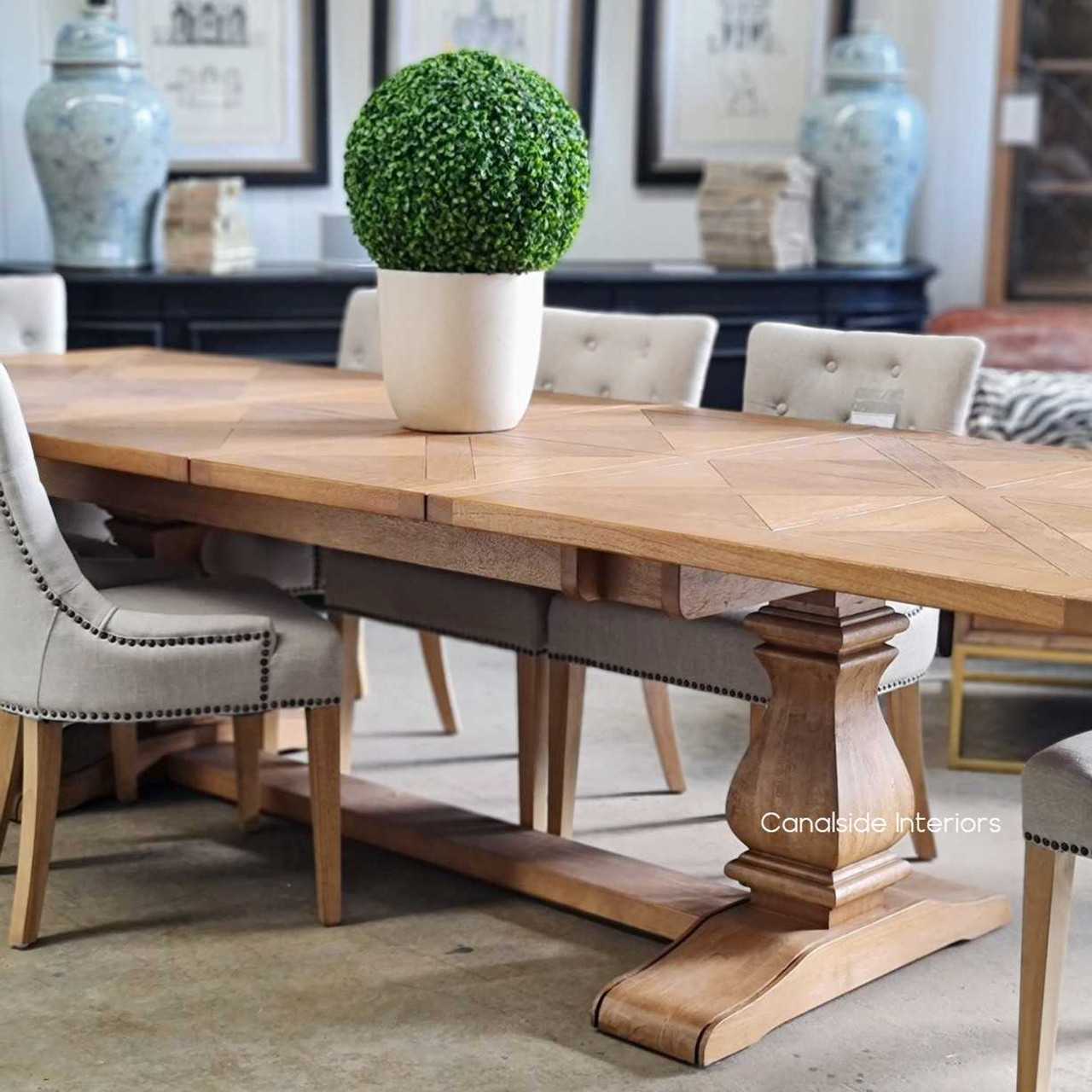 Close-up of the table's timeless pedestal trestle base, emphasizing the stability and elegant design that anchors the dining space.