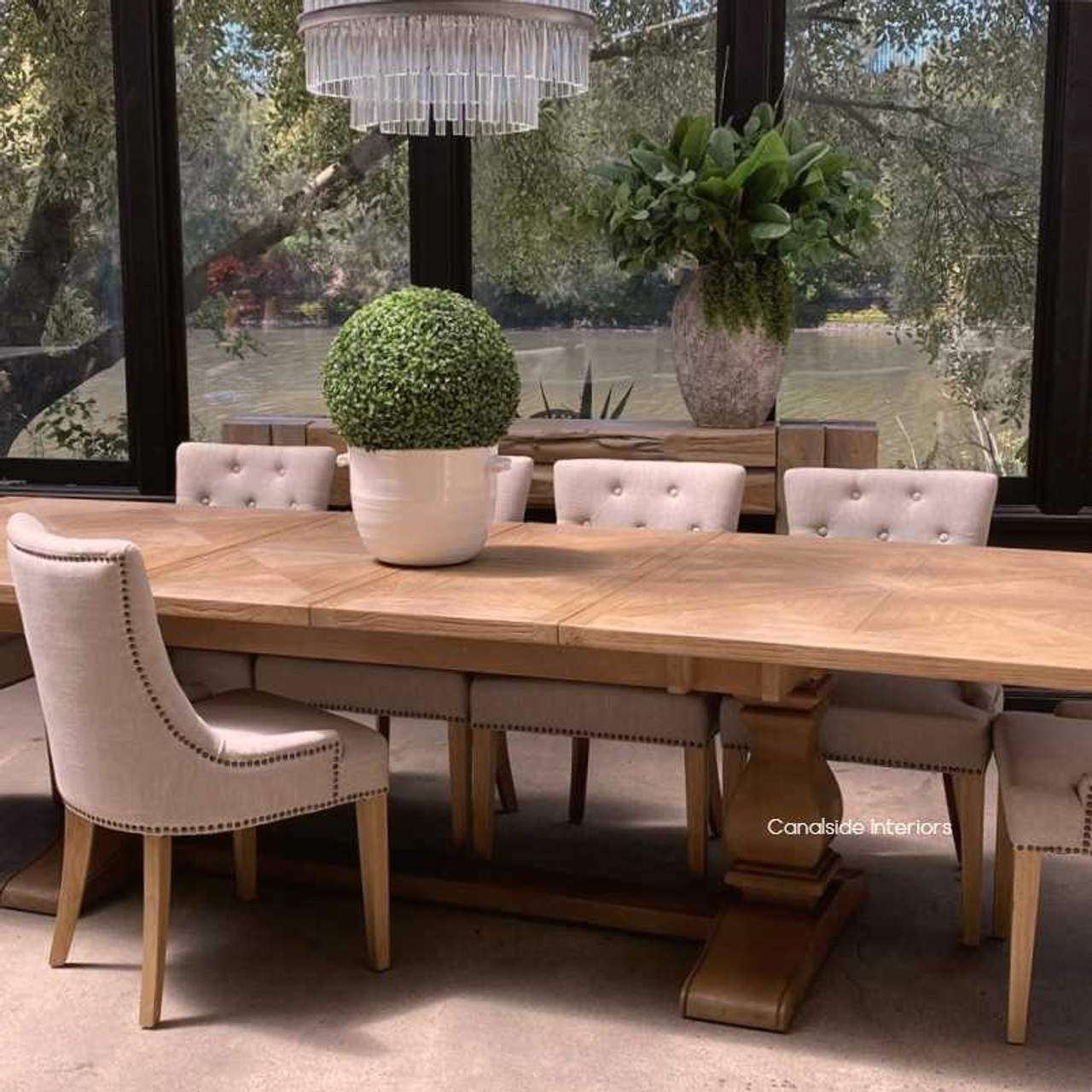 View of the table in a contemporary setting, emphasizing its modern elegance and the contrast between the wood and the fruitwood base.