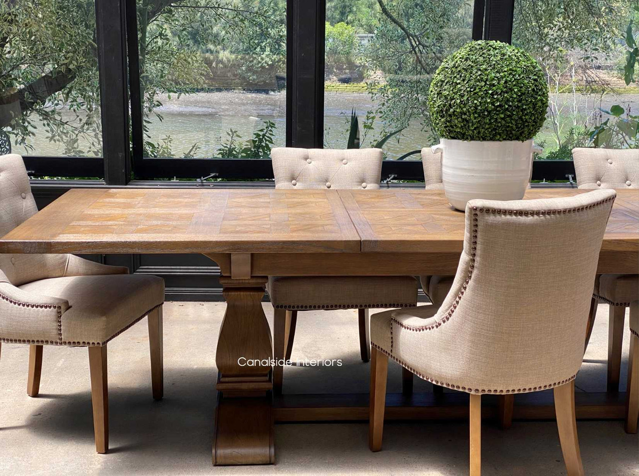 Positioned in a contemporary open-plan living space, the table seamlessly integrates dining and living areas.