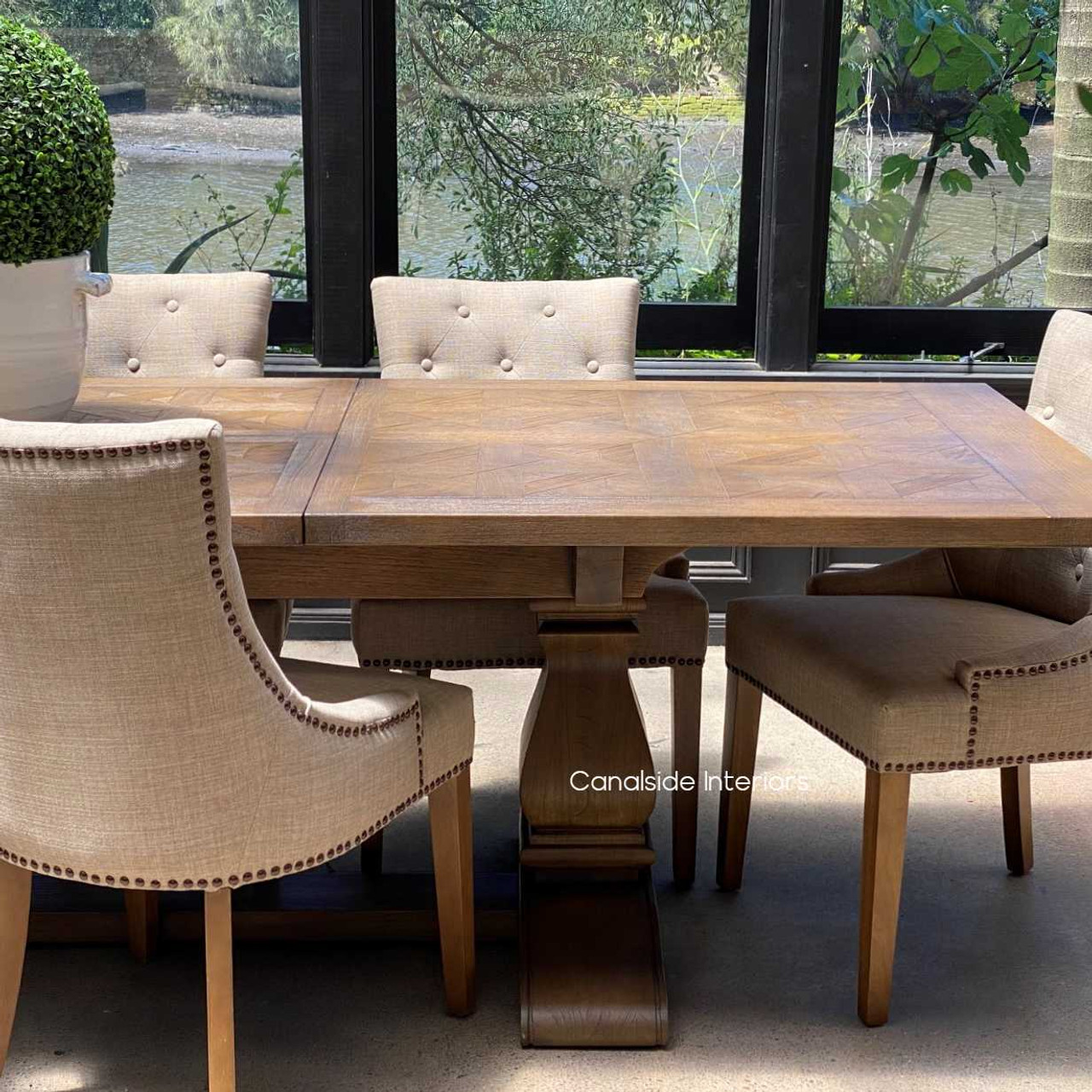 Close-up on the table’s edge, showcasing the precision of the parquetry work and the elegant profile of the table.