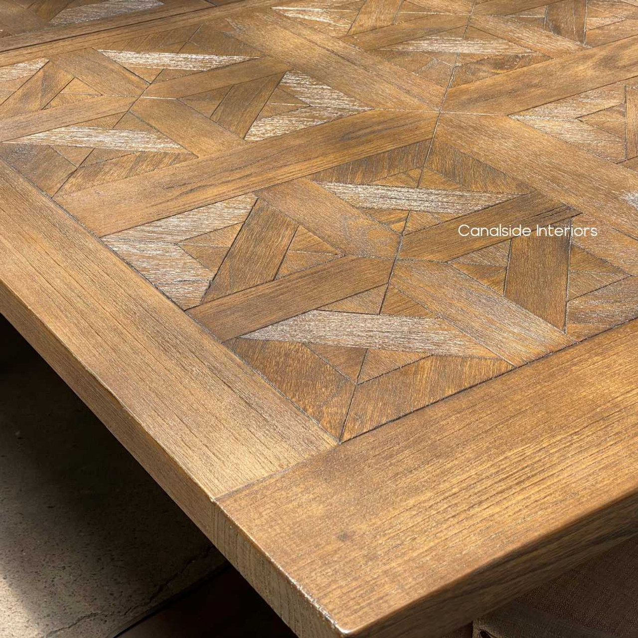 Close-up of the hand-crafted parquetry top, highlighting the meticulous detail and textural yet smooth finish.