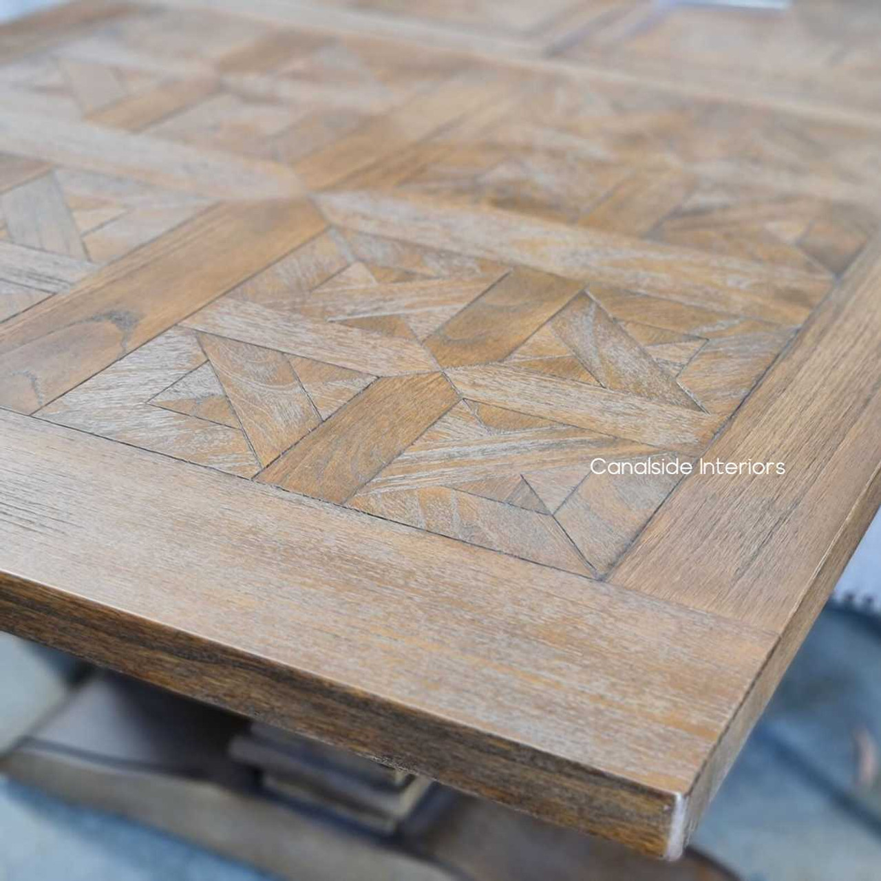 Close-up of the hand-crafted parquetry top, highlighting the meticulous detail and textural yet smooth finish.