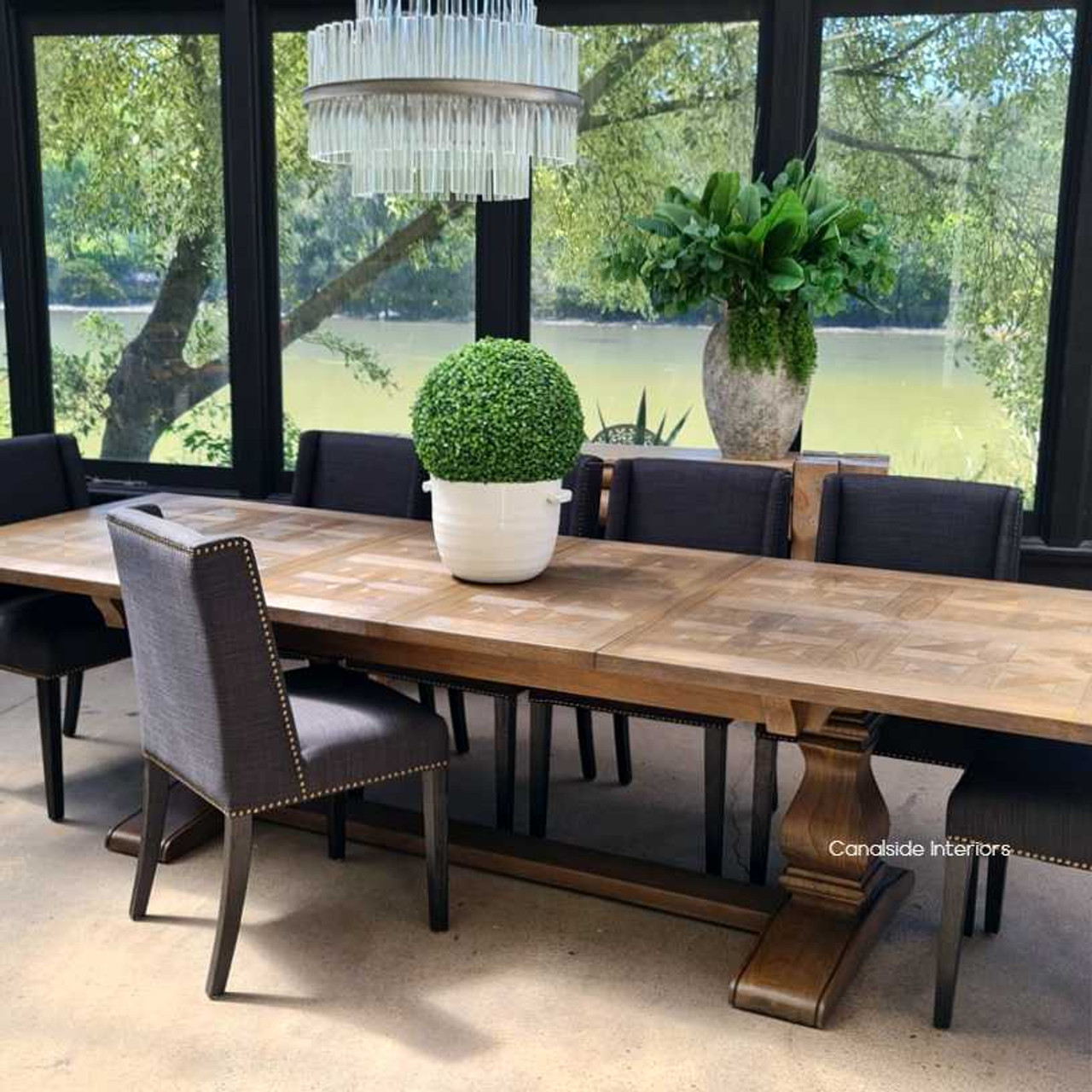 The dining table fully extended, set for a grand feast, emphasizing its capacity to host large gatherings with style.