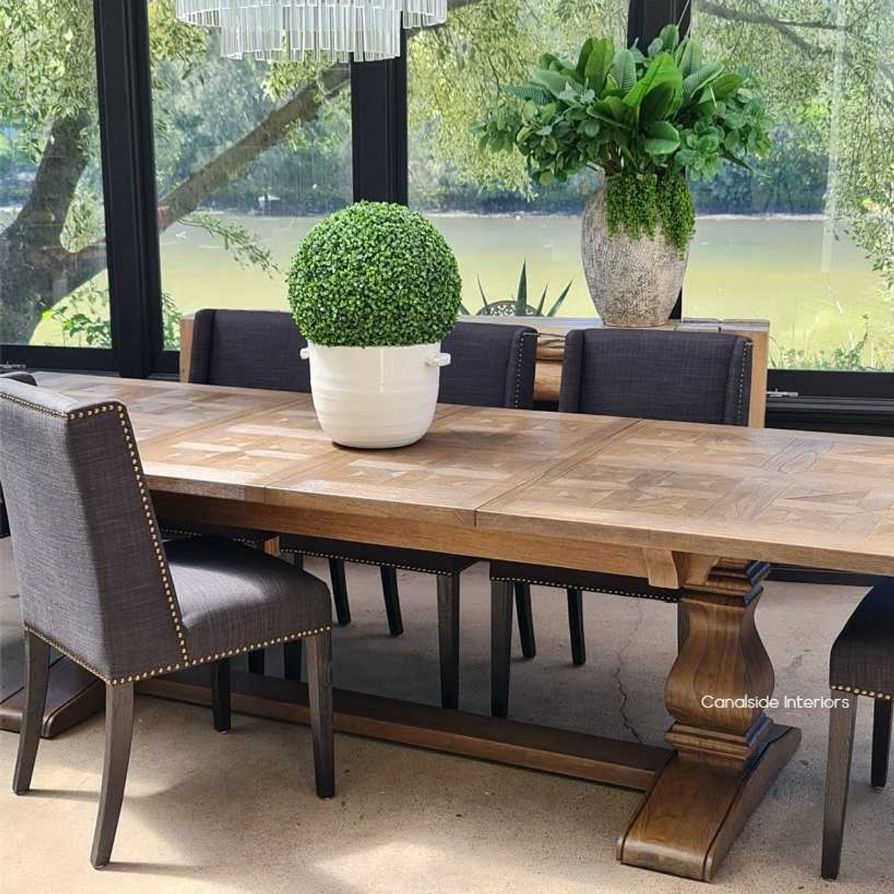 Frontal view of the Provence Parquetry Dining Table in its compact form, showcasing the intricate parquetry top and elegant white cedar base.