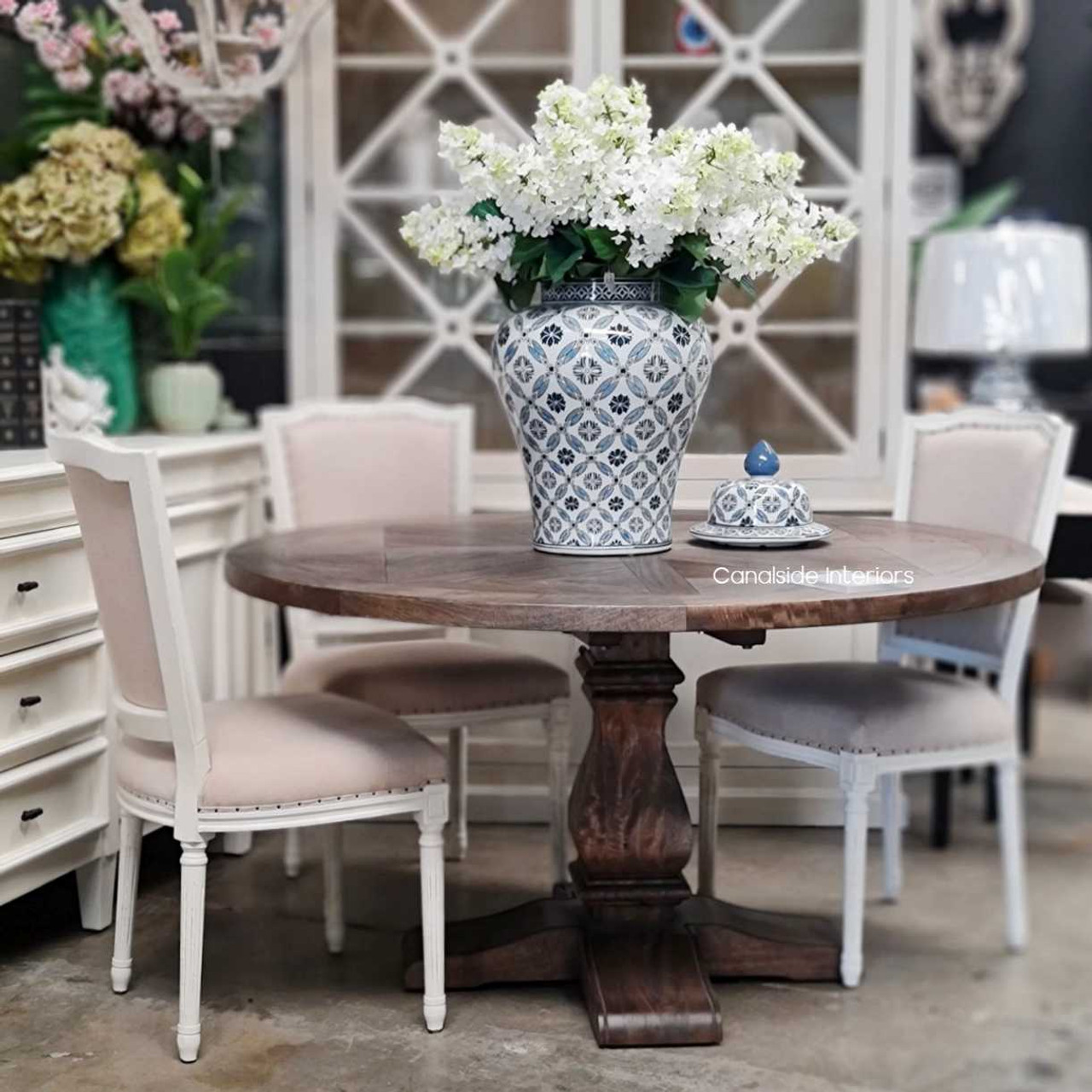 The dining table amidst classic decor, showcasing its ability to complement a wide range of interior themes with its chic design and fruitwood finish.