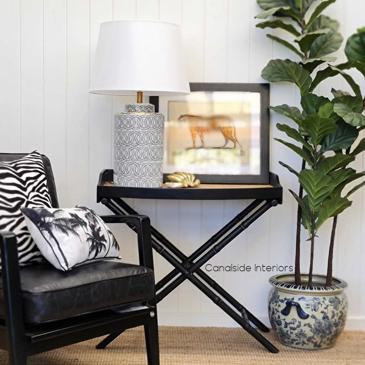 Distressed black Raffles Rattan Campaign Table with classic British Colonial charm for a stylish bedroom