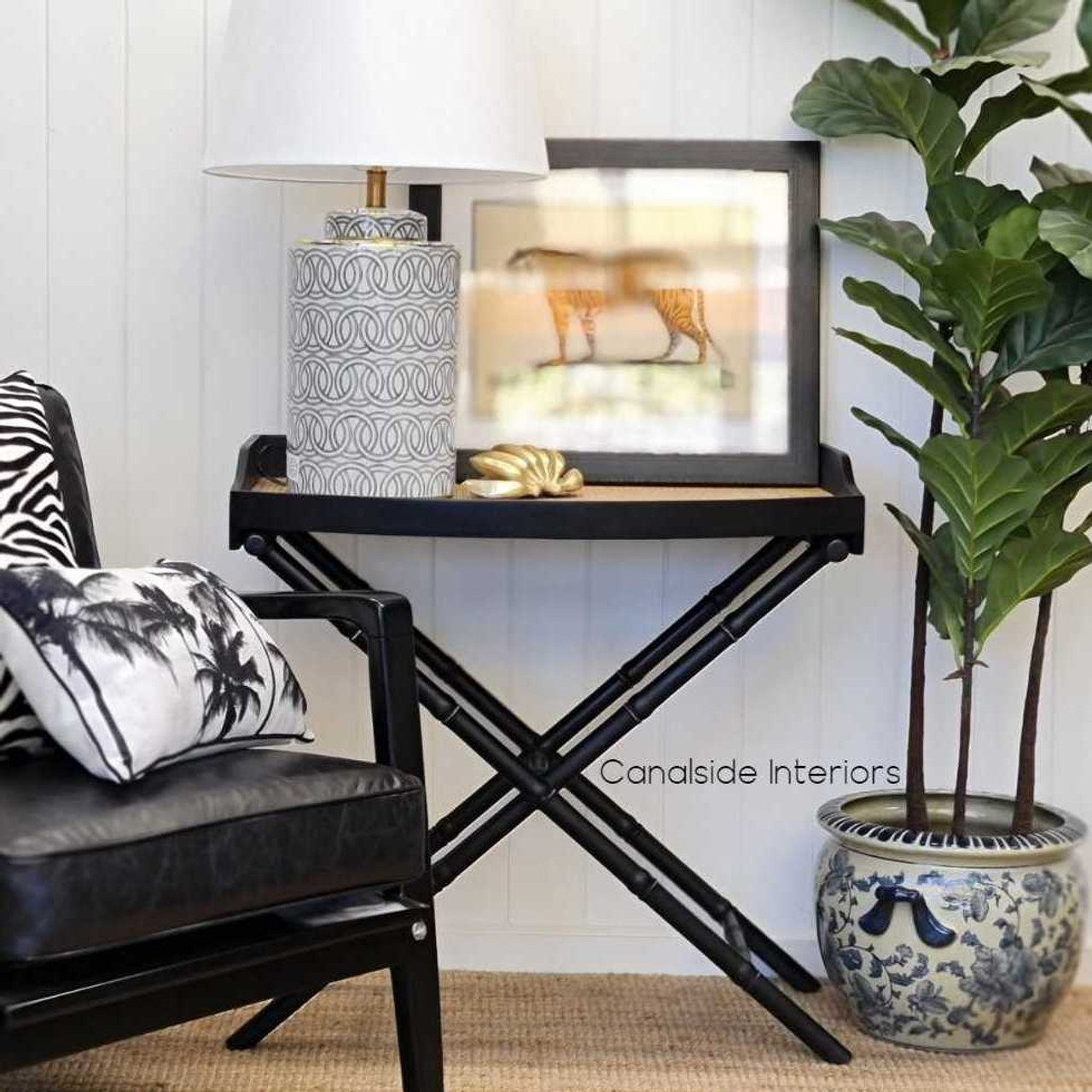 Distressed black Raffles Rattan Campaign Table with classic British Colonial charm for a stylish bedroom