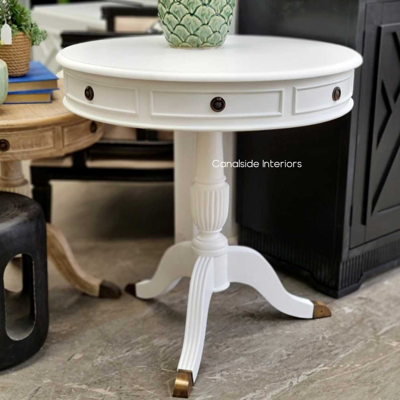 The Canalside Interiors' Cobble Hill Large Round Table in distressed white is a perfect centerpiece for a stylish lounge room, offering quality and a timeless Hamptons look.