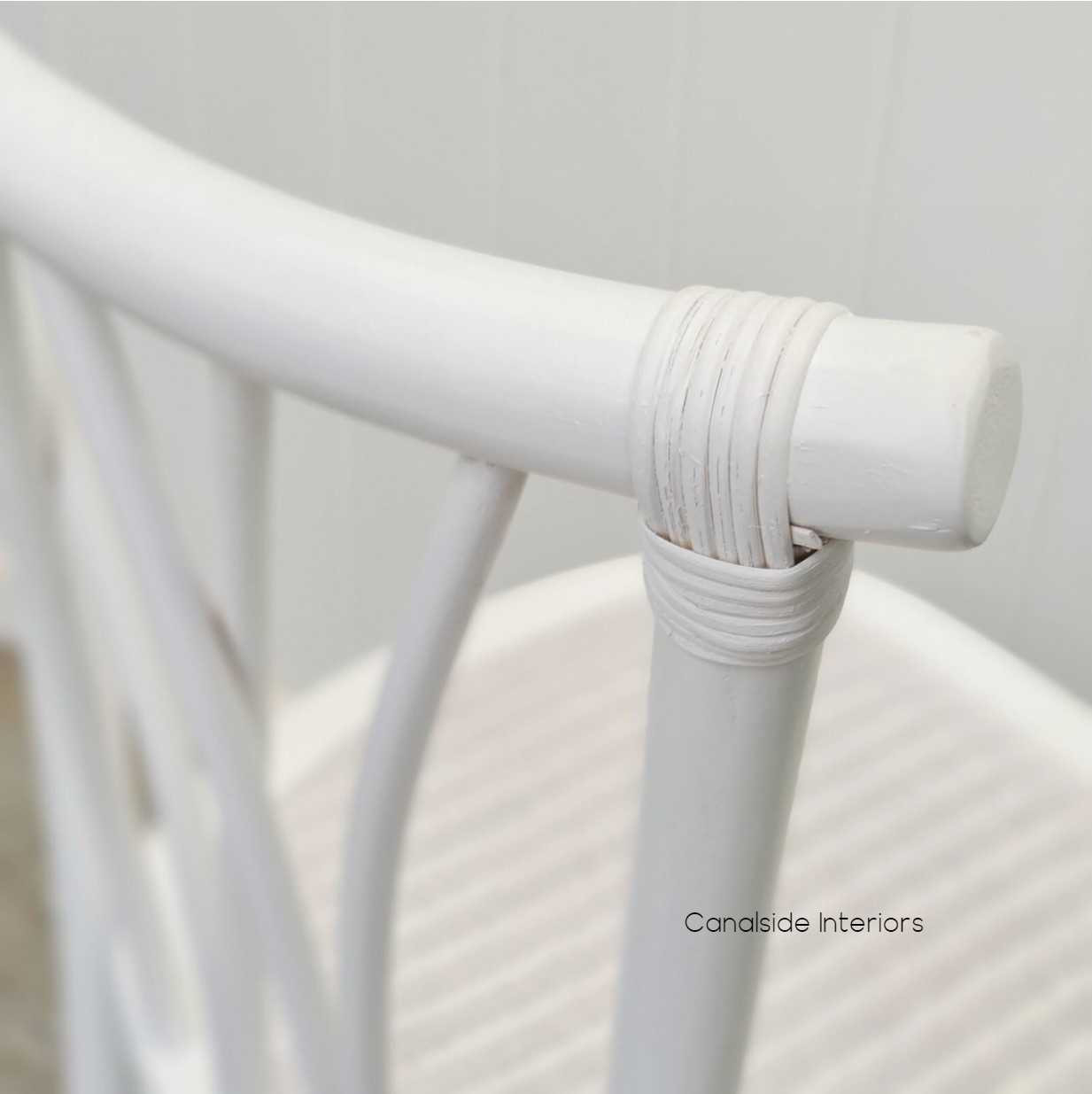 The chair captured in a well-lit dining area, showcasing its reflective quality and the timeless design that suits any home style.