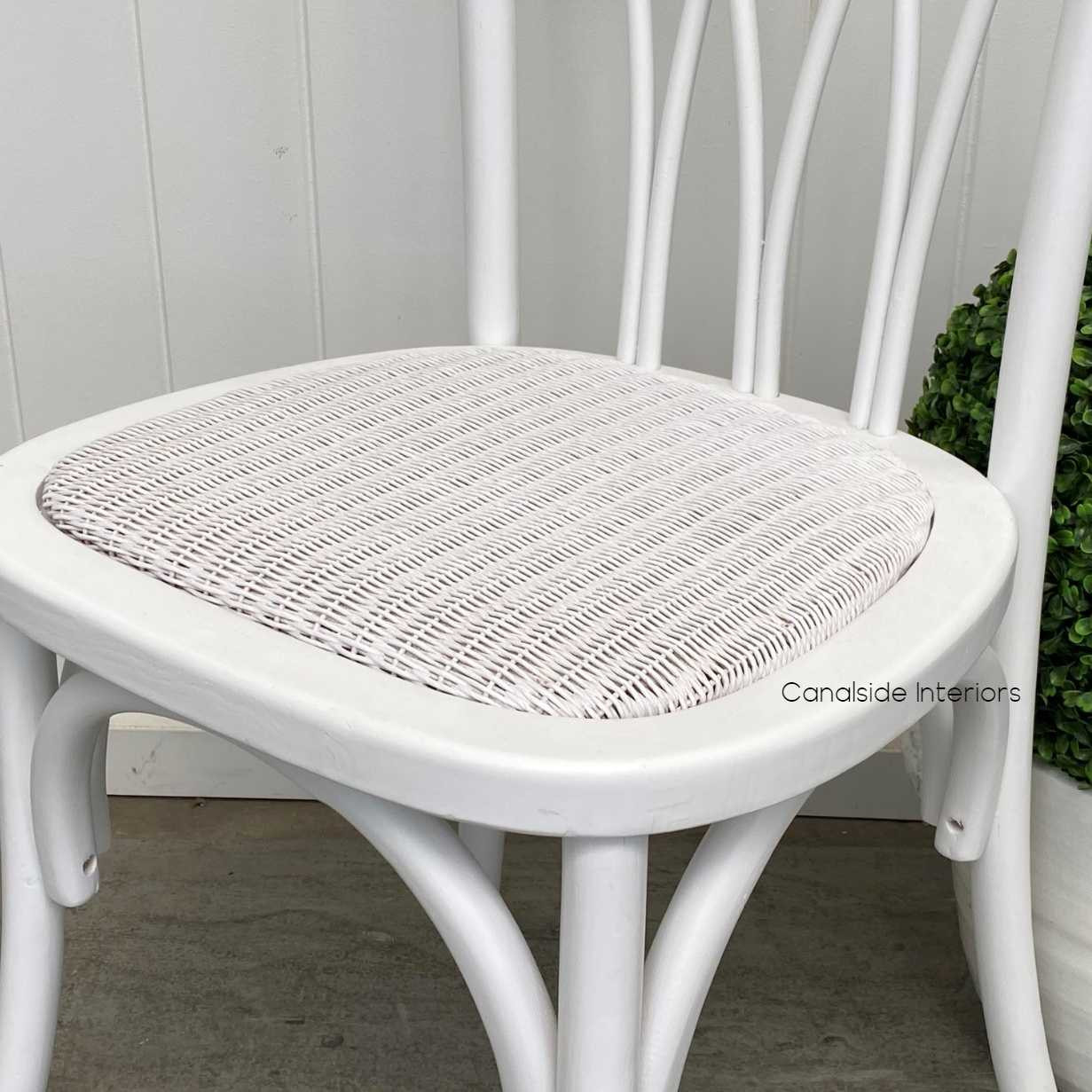 Close-up on the rattan seat of the Botanica Chair, highlighting the comfort and elegance of the slight padding and woven texture.