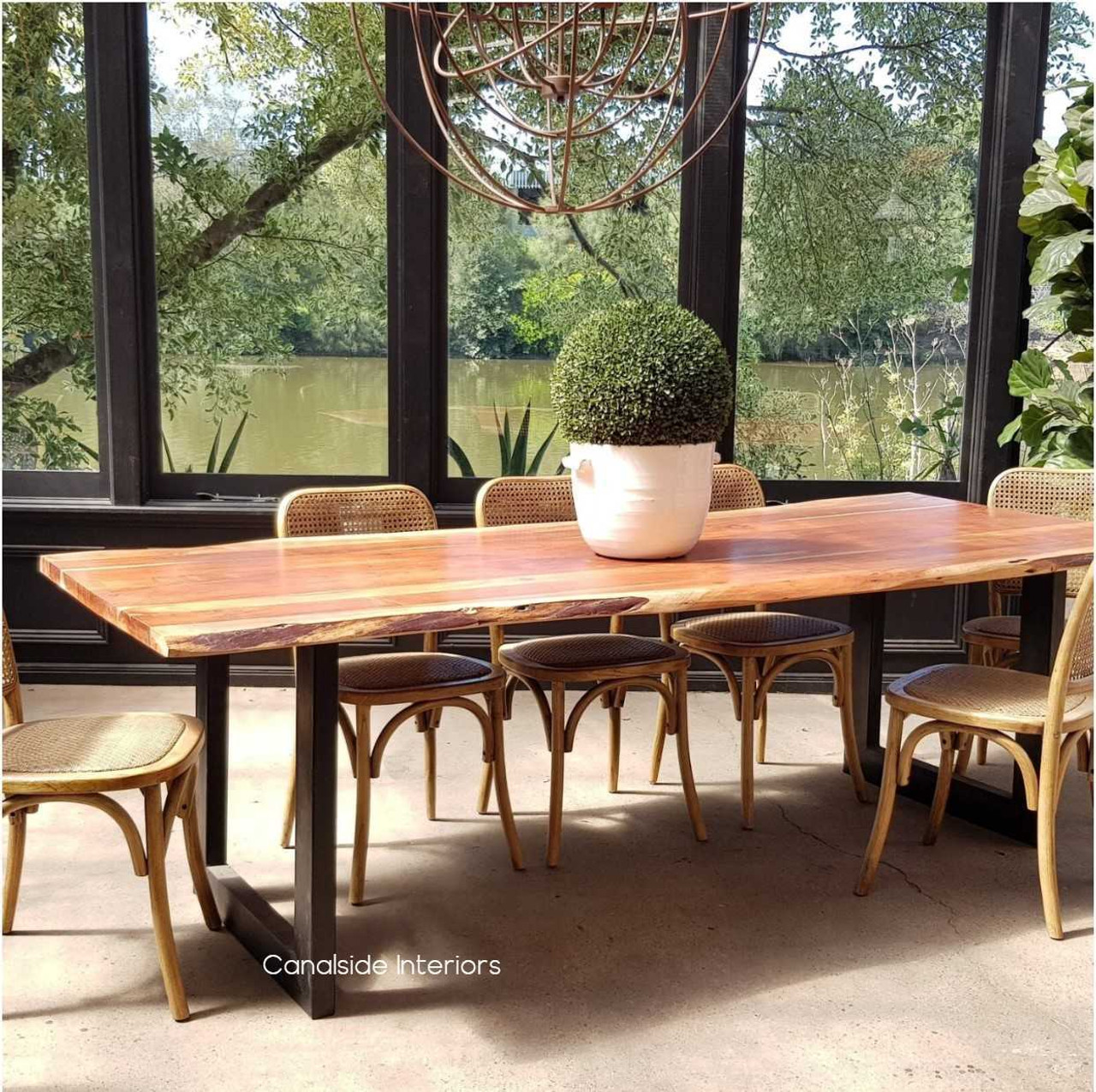 Angled view emphasizing the tabletop's thick wood slab, illustrating the blend of industrial strength and natural elegance.