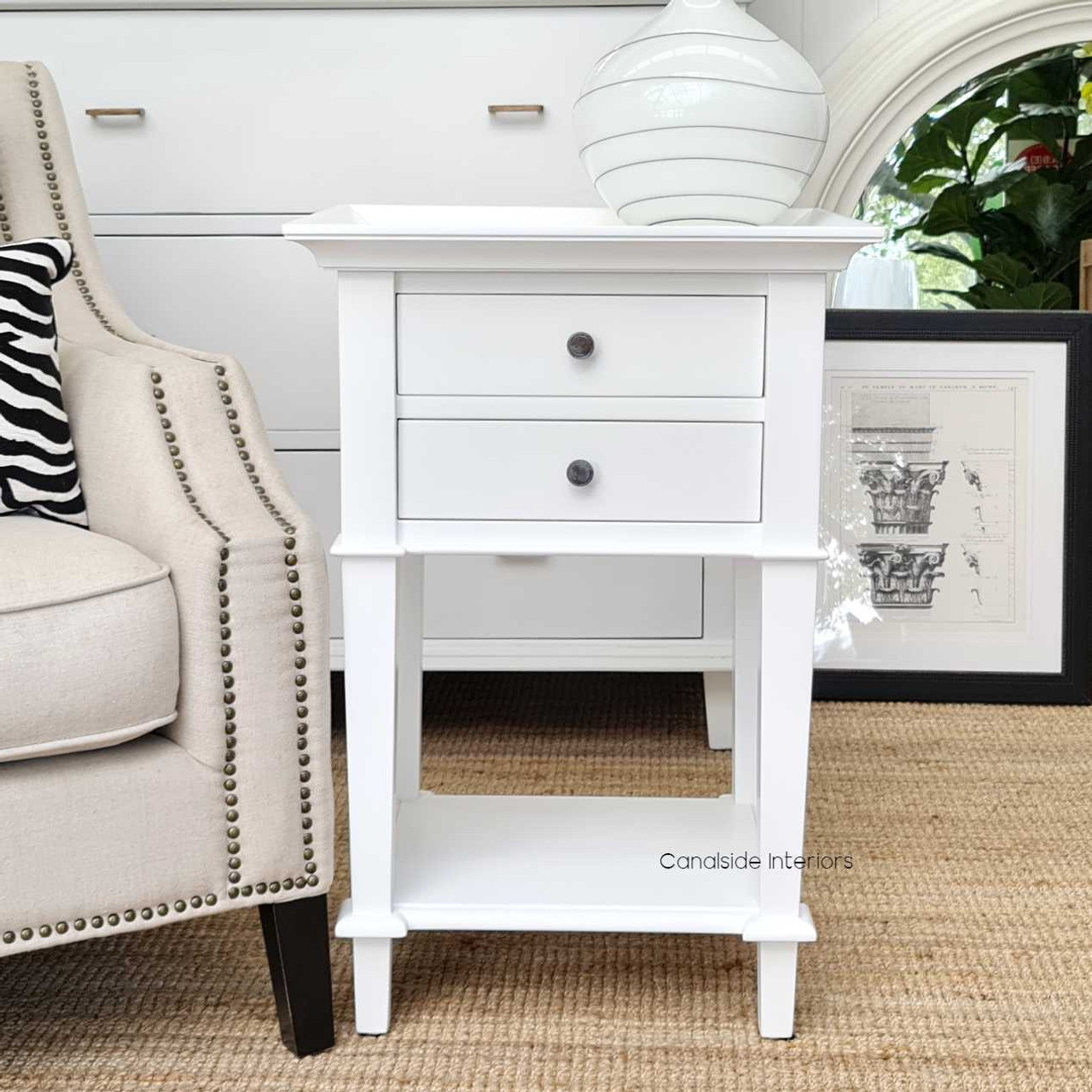 Profile shot against a light-colored wall, accentuating the table's elegant lines and timeless design.