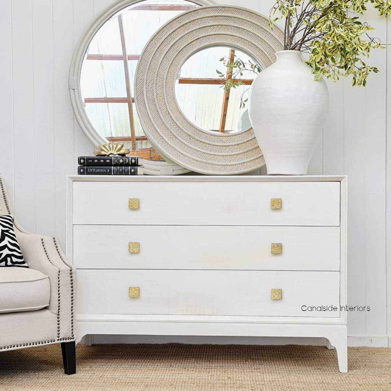 Profile view against a minimalist wall, highlighting the round silhouette and the blend of traditional and contemporary influences.