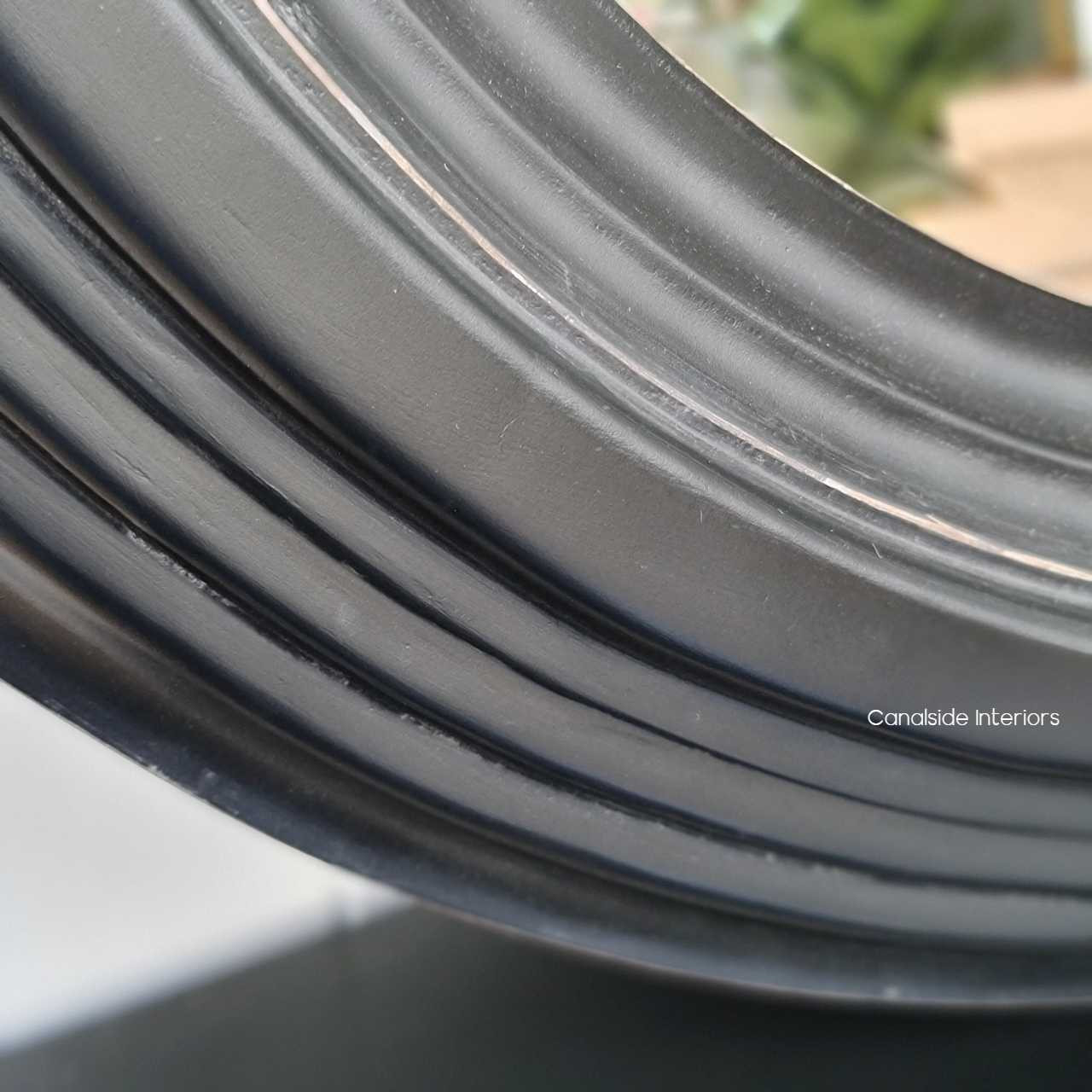 Close-up of the Aspen Mirror's frame, reflecting the attention to detail and high-quality materials used in its design.