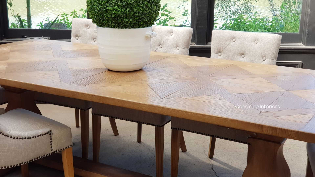 Detailing the contrast between the parquetry top and the smooth finish of the legs, illustrating the meticulous attention to detail and craftsmanship.