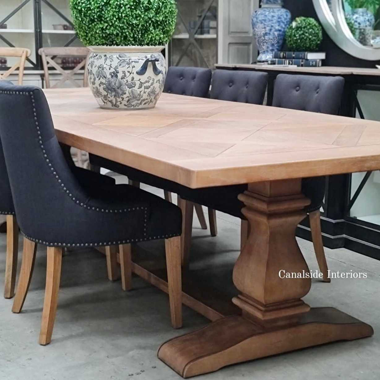 The table as part of a sophisticated dining setup, to demonstrate its elegance and suitability for formal dining.