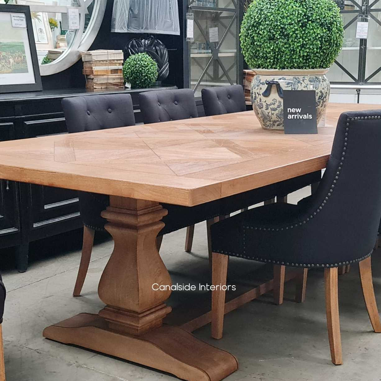 Close-up of the solid fruitwood base, highlighting its robust construction and the stability it provides to the expansive tabletop.