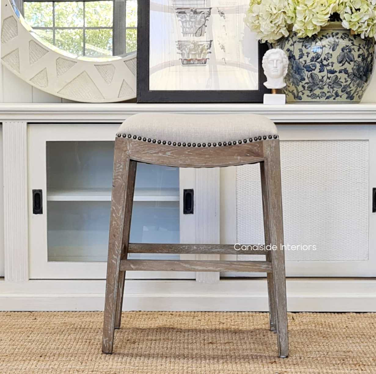 The Mila II Stool in a living room setting, showcasing its versatility beyond the kitchen as a chic side seating option.