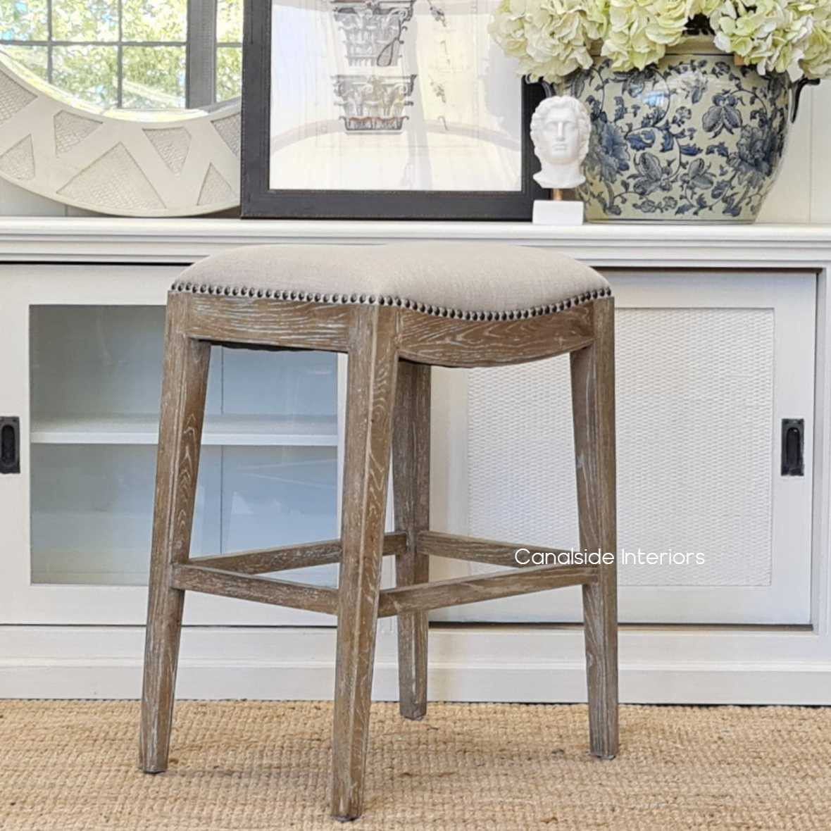 Side view of the Mila II Bar Stool, highlighting the greywash weathered oak base and the sleek, modern silhouette of the stool.