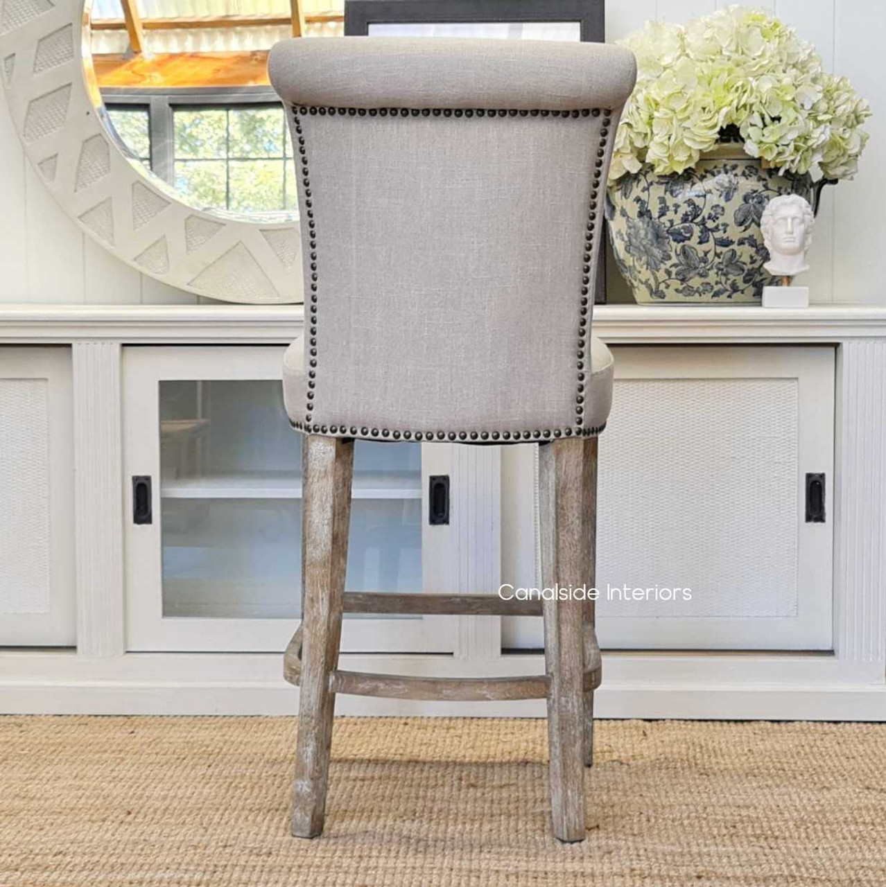 View on the exquisite button detailing, brass studding and cream fabric, offering a closer look at the texture and quality that make this stool a must-have for modern, quality-conscious interiors.
