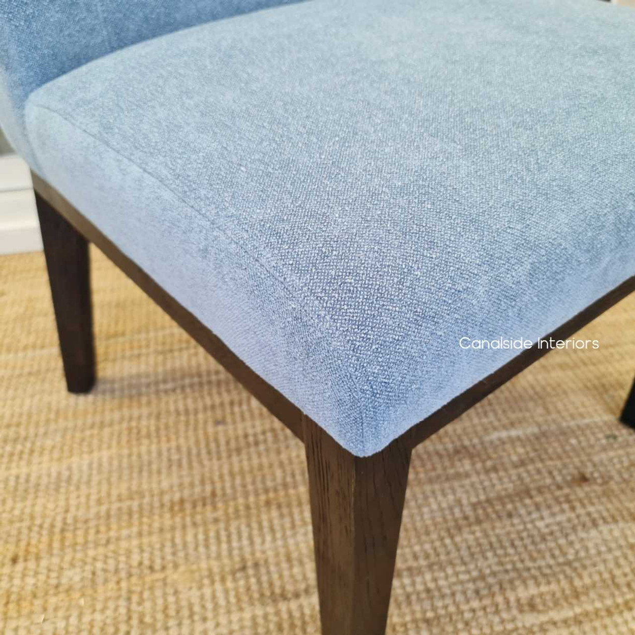 The Norris Dining Chair's deep espresso legs anchor the light, airy Hamptons Blue upholstery, perfect for a Canalside Interiors-inspired library