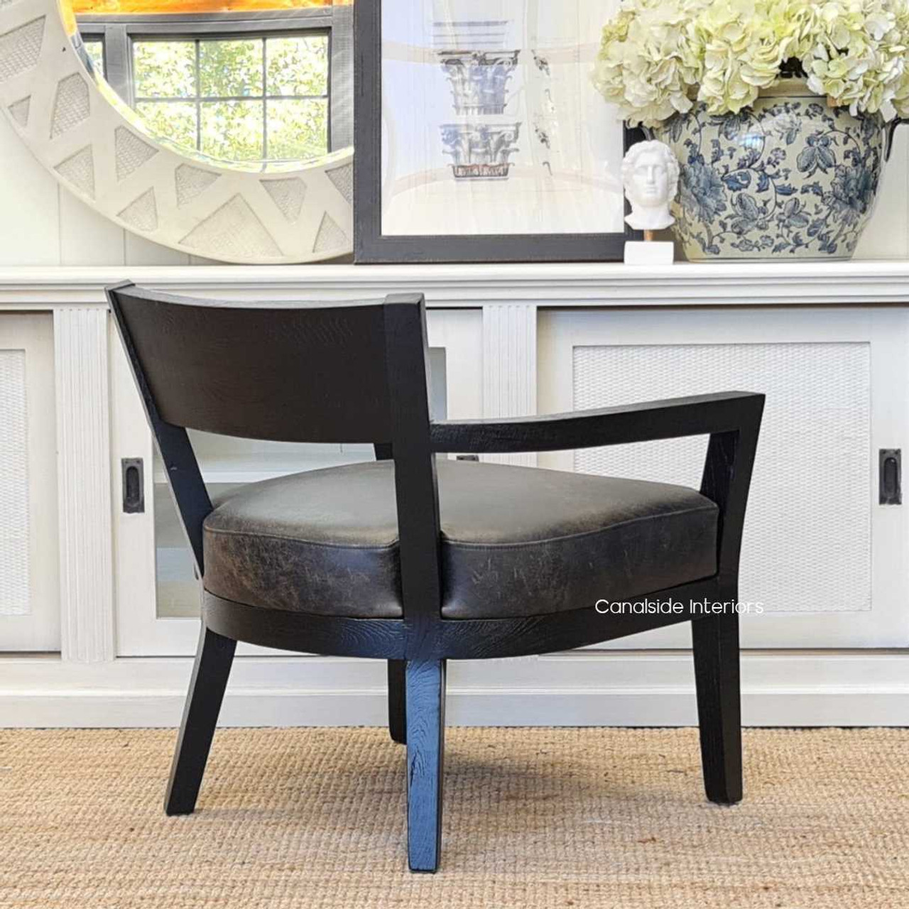 A detailed look at the armchair's legs, highlighting the solid construction and espresso finish that grounds the piece in stability and style.