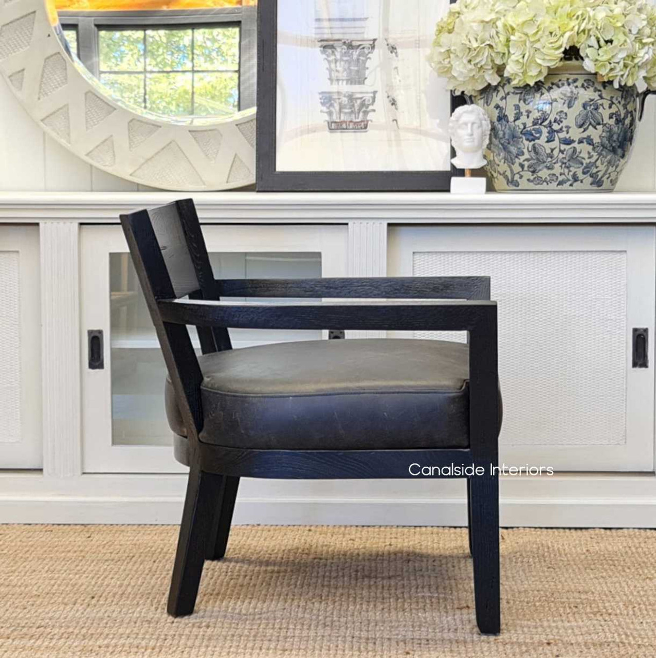 Side perspective of the Vettel Armchair, focusing on the depth of the seat and the perfect balance between comfort and style.