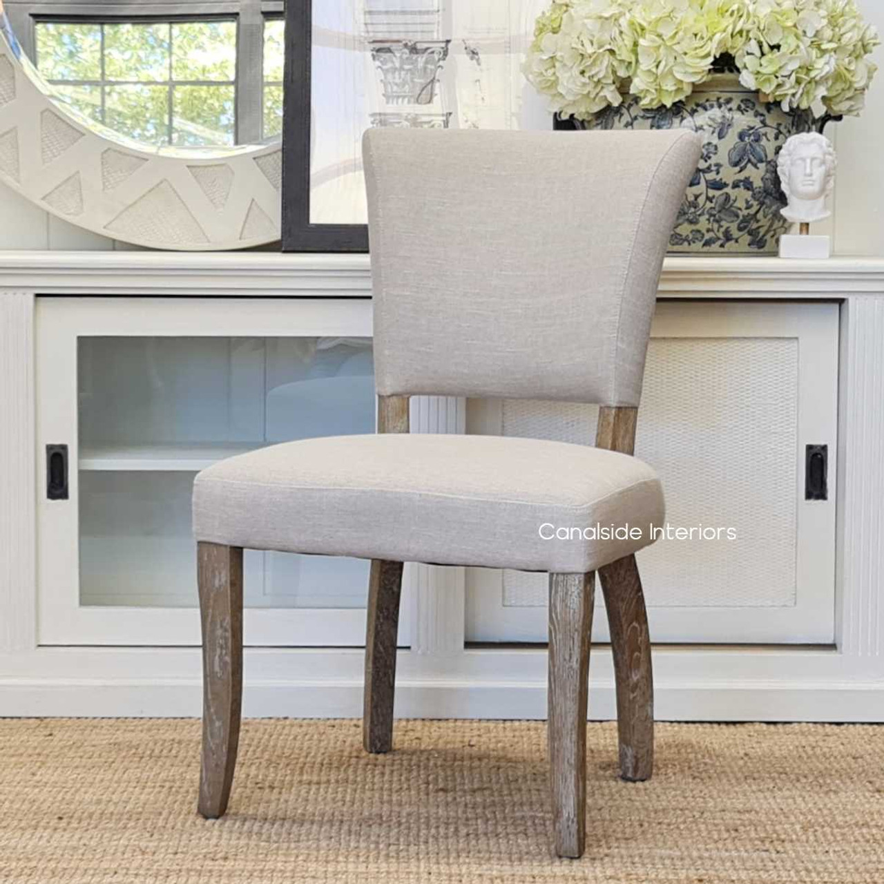 The Mimi Dining Chair set in a living room exemplifying how it complements both contemporary and classical dining room decors.