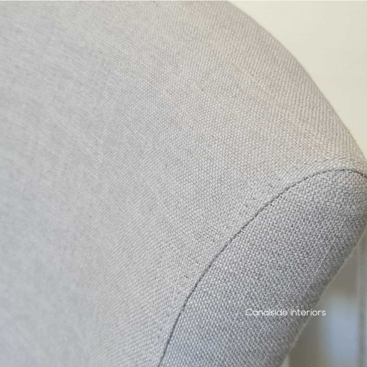 Angled view emphasizing the chair's cream upholstery, perfect for adding a touch of timeless quality to modern interiors.