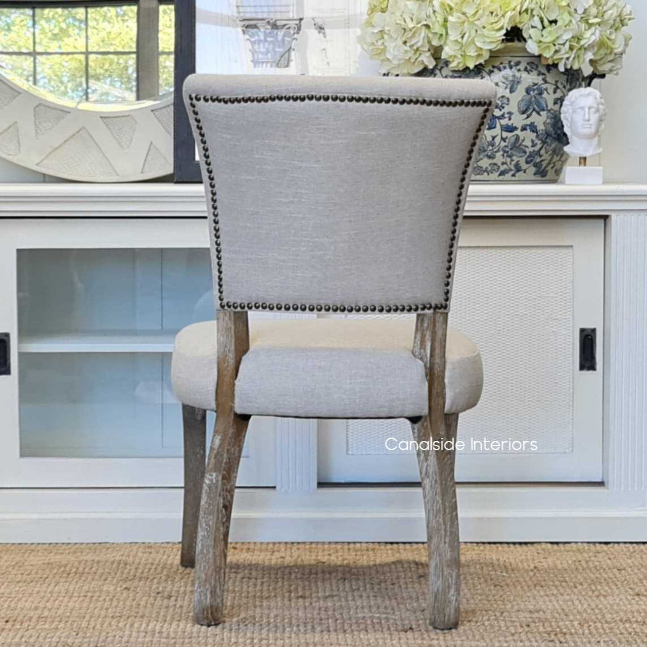 Rear view of the Mimi Dining Chair, focusing on its unique back design and the subtle details that add to its sophisticated appeal.