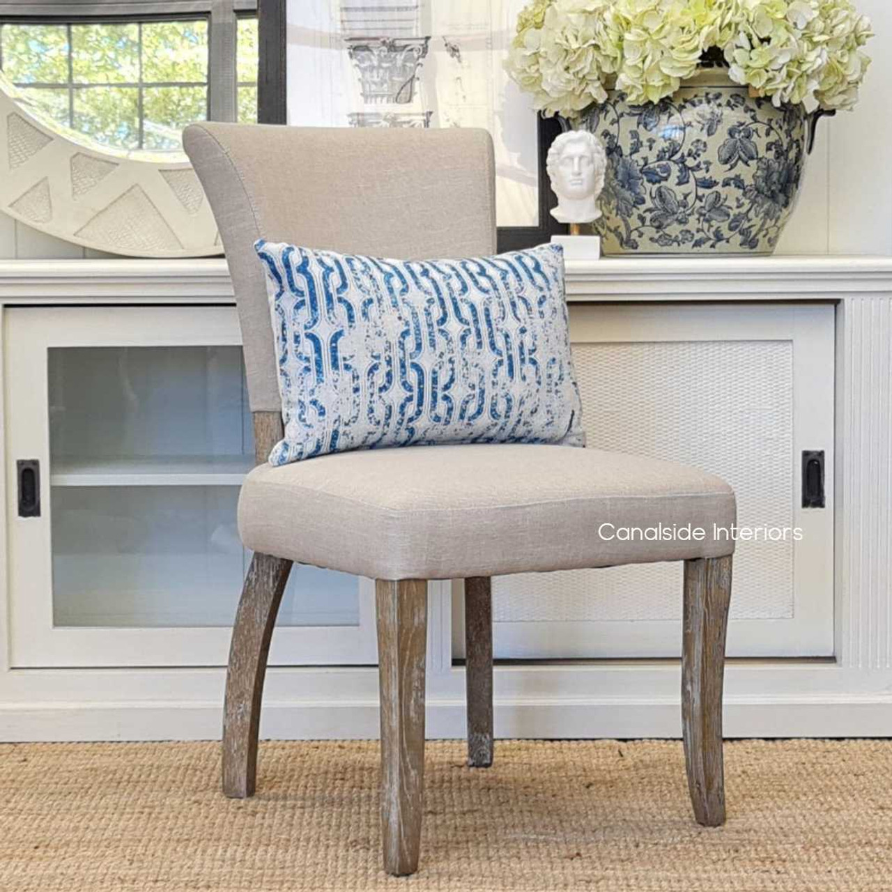 A cozy living room setup featuring the Mimi Dining Chair, illustrating its versatility in both formal and casual settings.