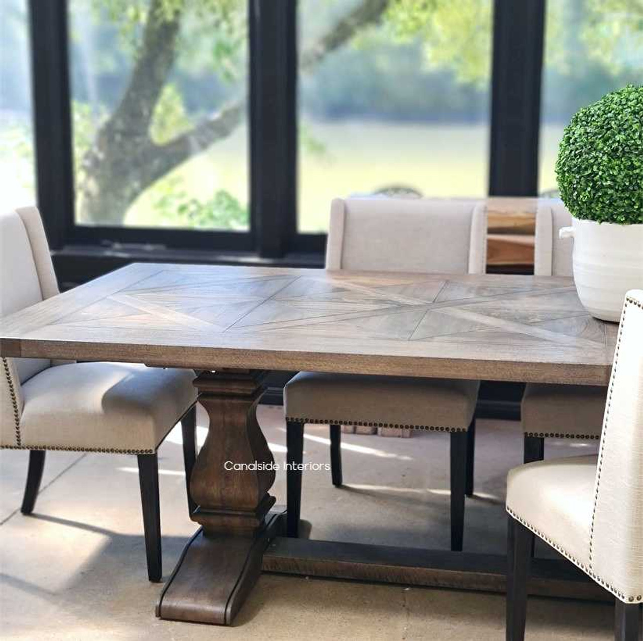 The table set within a minimalist contemporary setting, emphasizing its ability to stand out as a statement piece with its unique design and traditional charm.