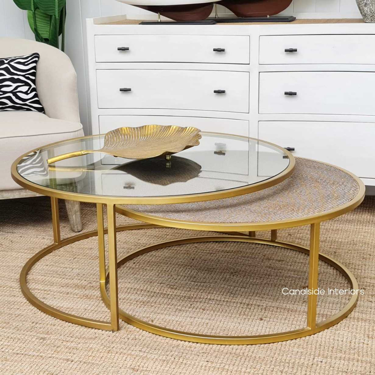 The larger Knox Table with its sleek glass top offers a modern centerpiece, while its rattan-topped counterpart nests beneath for a smart space solution