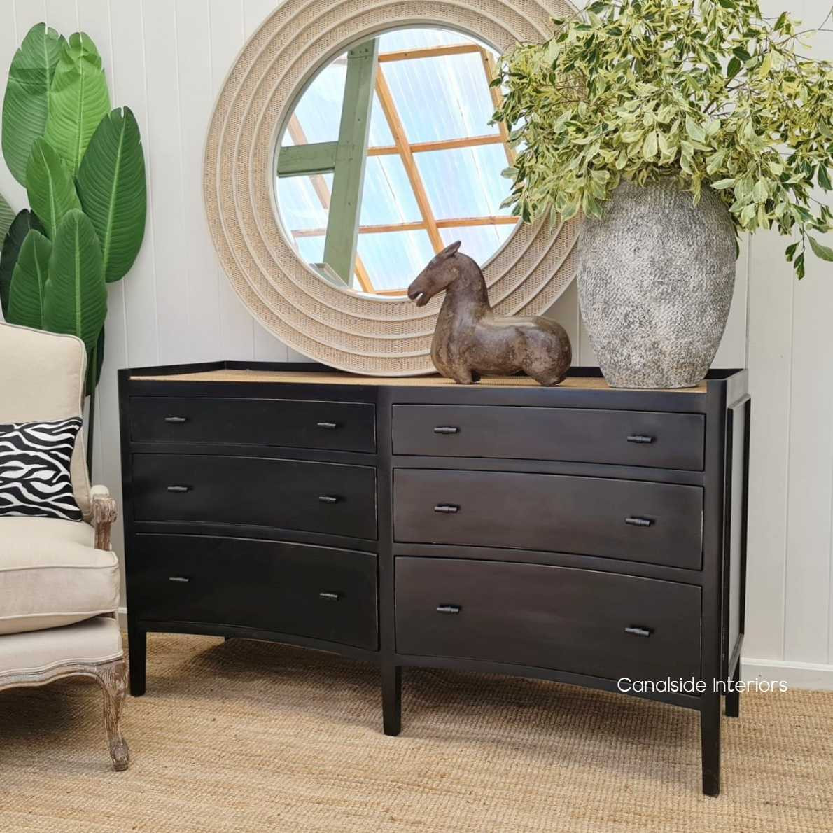 Staged within a Hamptons-inspired living space, the grande double chest complements the coastal aesthetics with its natural rattan and charcoal finish.