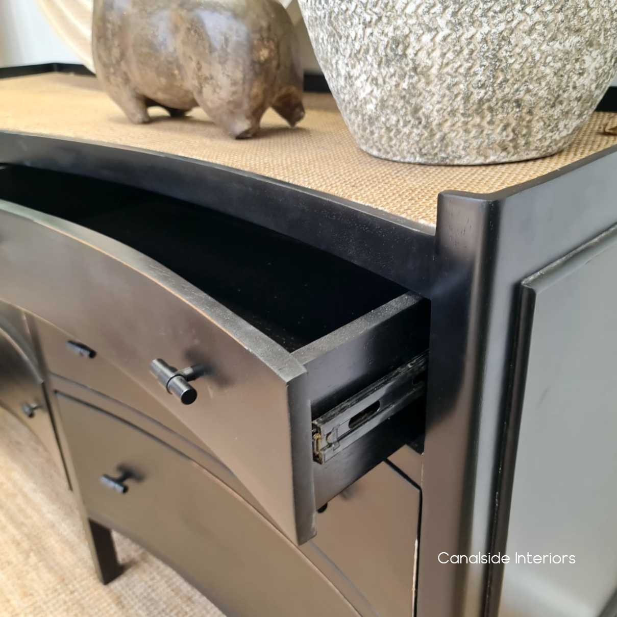 Detail view of the drawers on metal runners, emphasizing the blend of traditional craftsmanship with modern functionality for smooth operation.