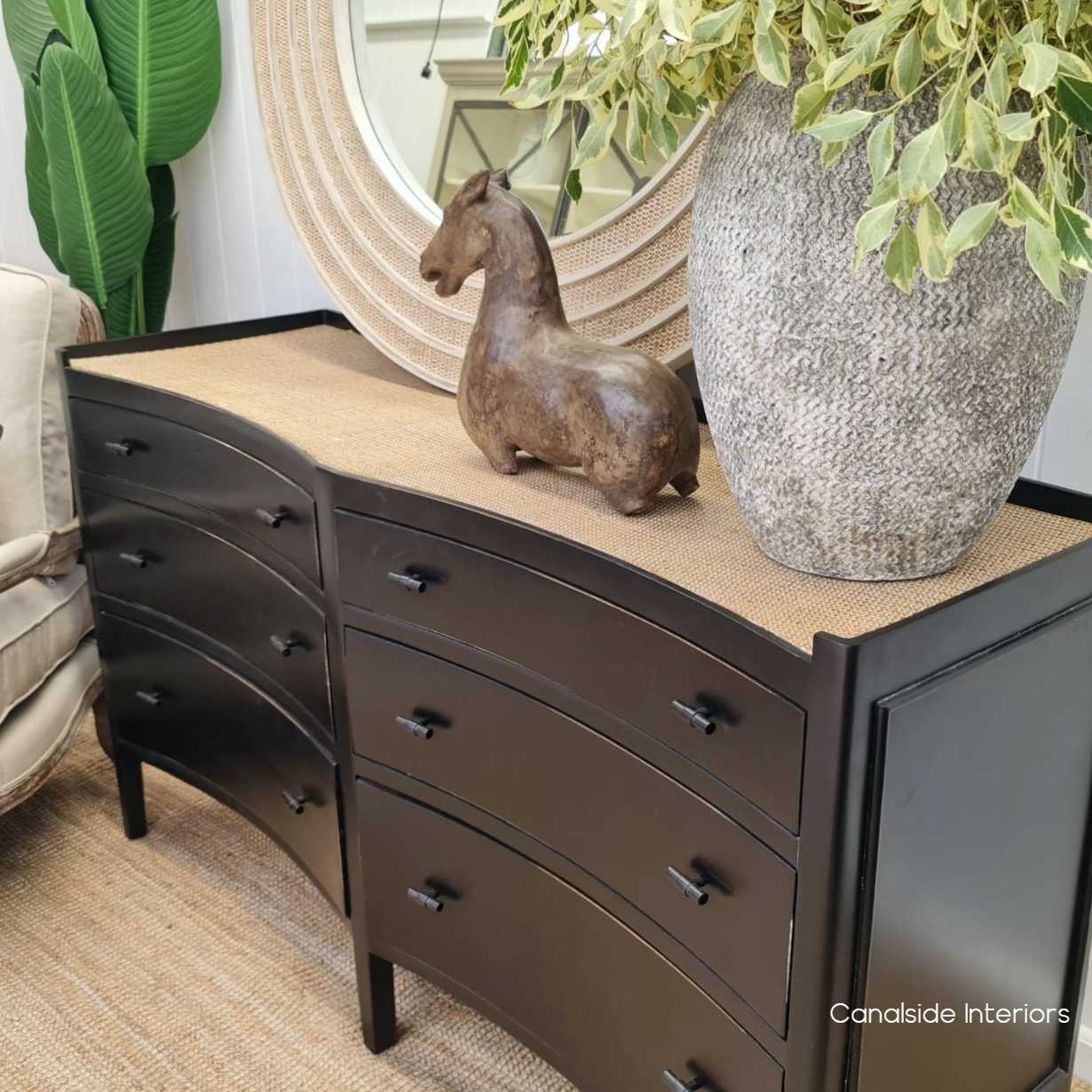 Angled shot highlighting the chest’s unique concave face design, adding architectural interest and depth to the spacious storage unit.