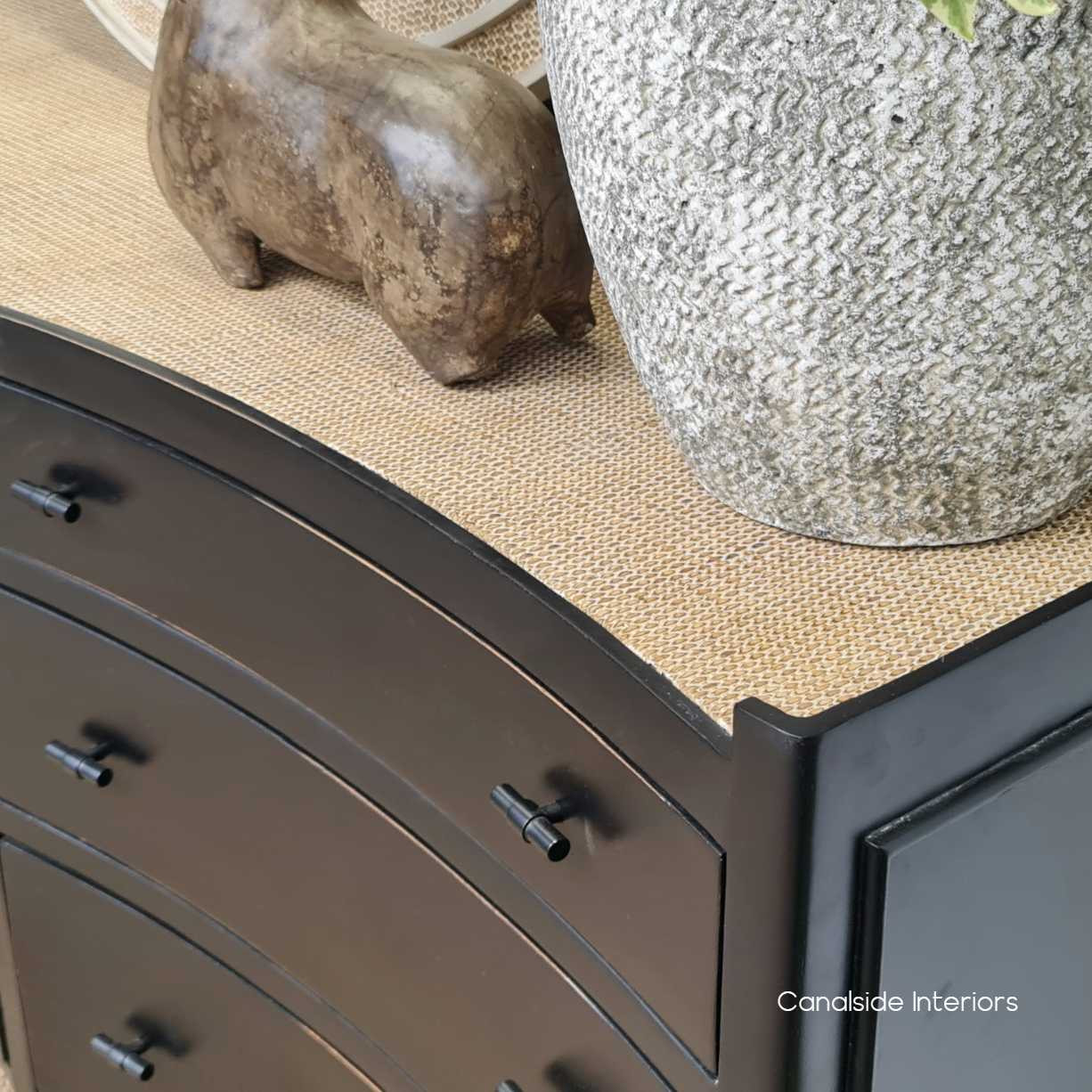 Close-up detail showcasing the intricate texture of the rattan top, contrasted beautifully against the chest’s distressed charcoal/black body.