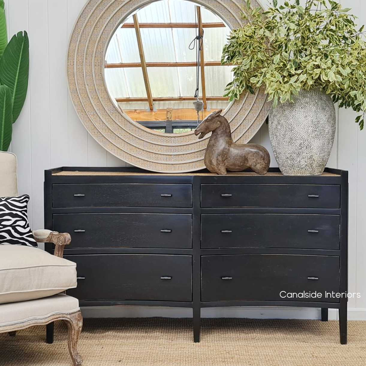 Elegant frontal view of the Tweed Hill Rattan Grande Double Chest in a distressed charcoal finish, set in a bedroom embracing the natural plantation island lifestyle.