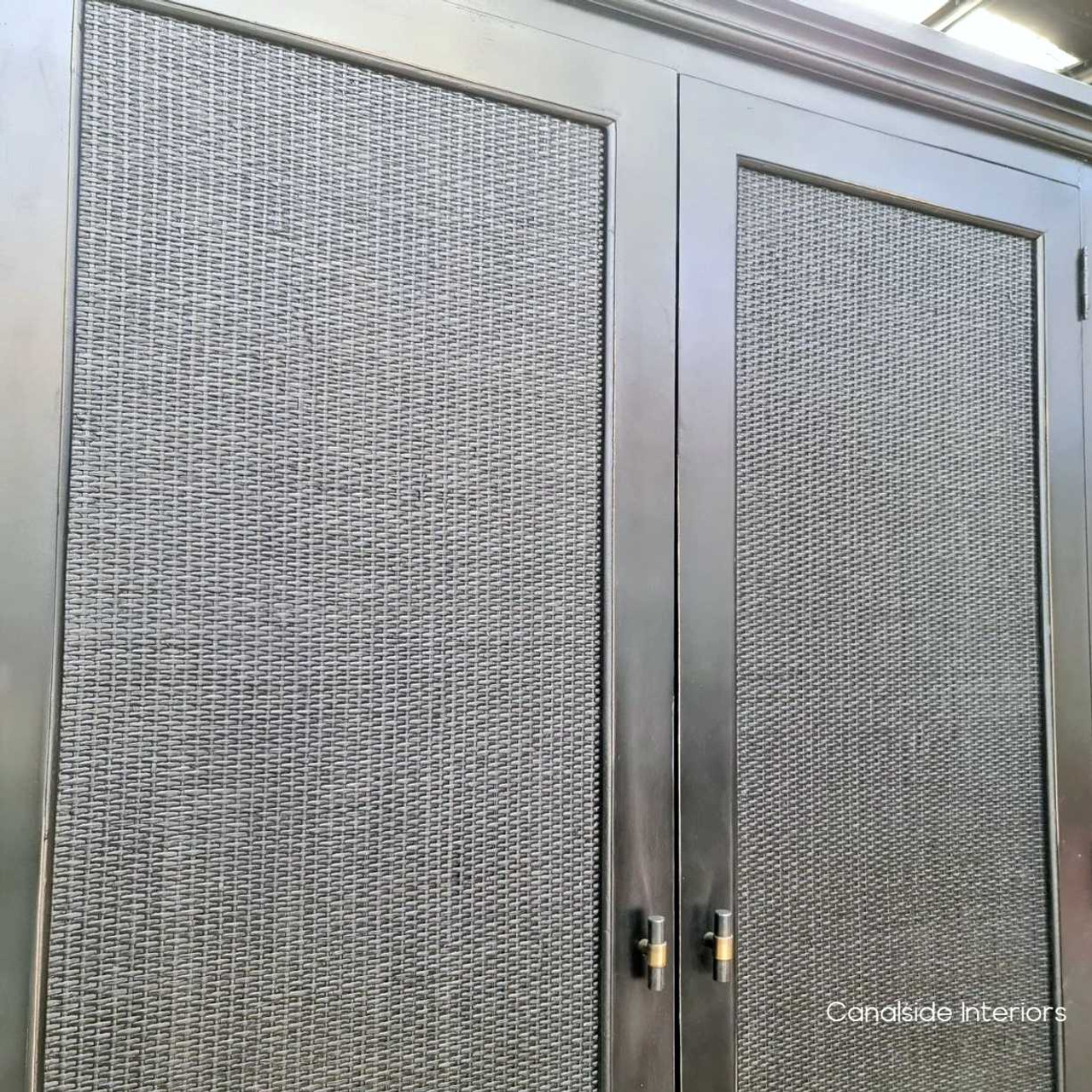 Detailed view of the distressed charcoal/black finish, highlighting the wardrobe's timeless appeal and elegance.