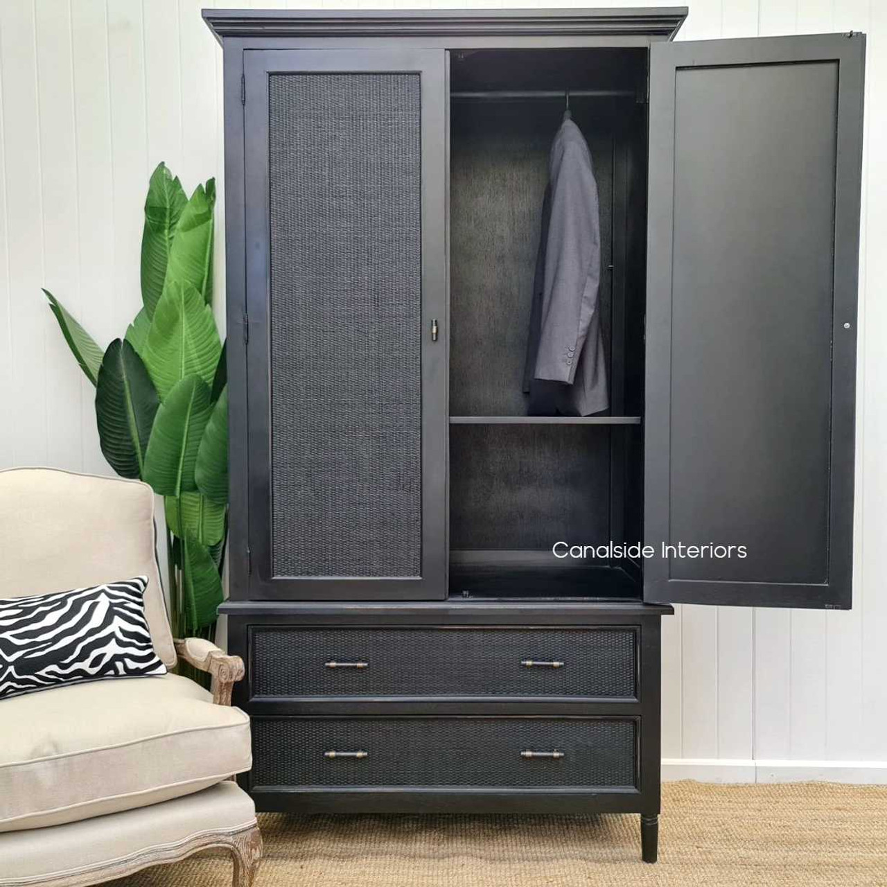 Natural light accentuating the texture and color variations of the charcoal/black rattan, enhancing the wardrobe's aesthetic appeal.