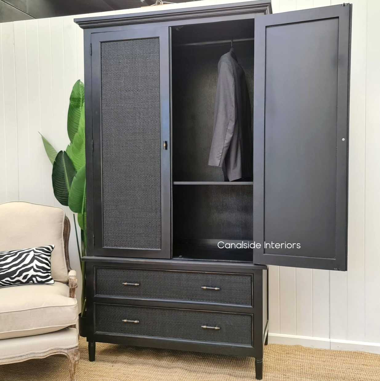 Interior shot revealing the wardrobe's practical hanging rod and adjustable, removable shelves for versatile storage options.