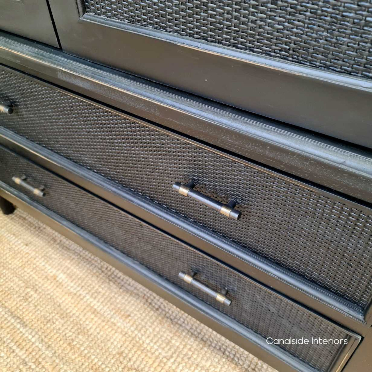Close-up of the elegant metal handles against the charcoal/black rattan, adding a luxurious touch to the functional design.