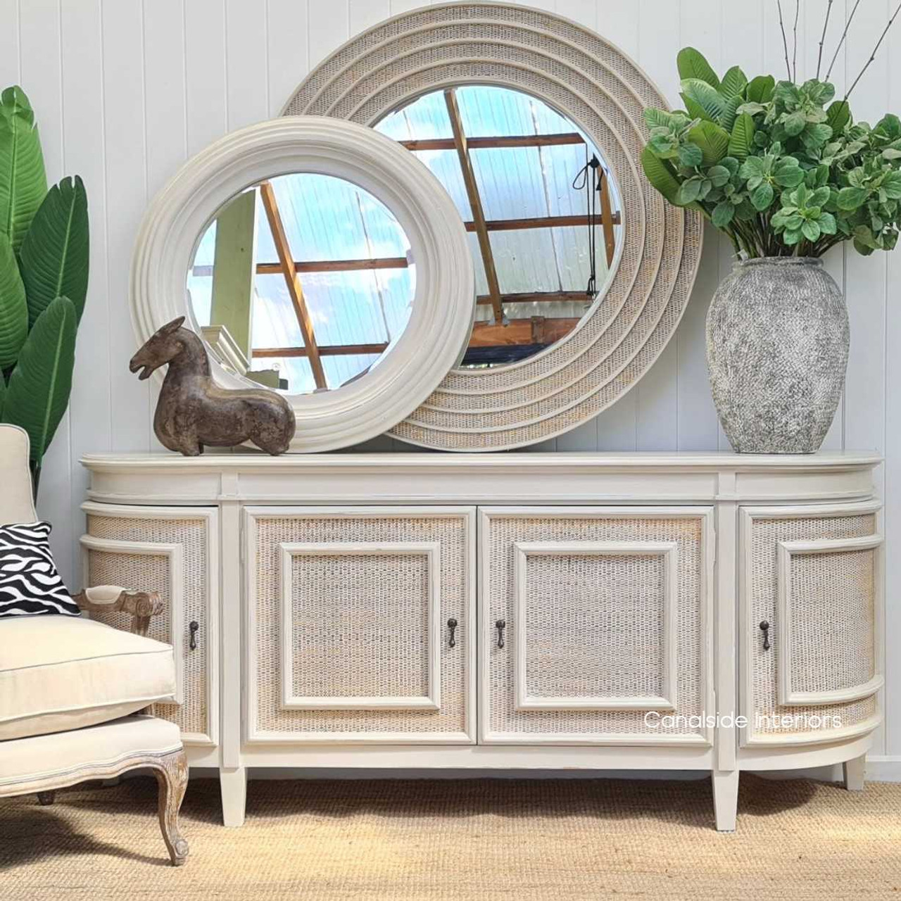 In the library, the Francia Sideboard stands as a colonial plantation-style classic, with its distressed stone finish and elegant rattan weave from Canalside Interiors.